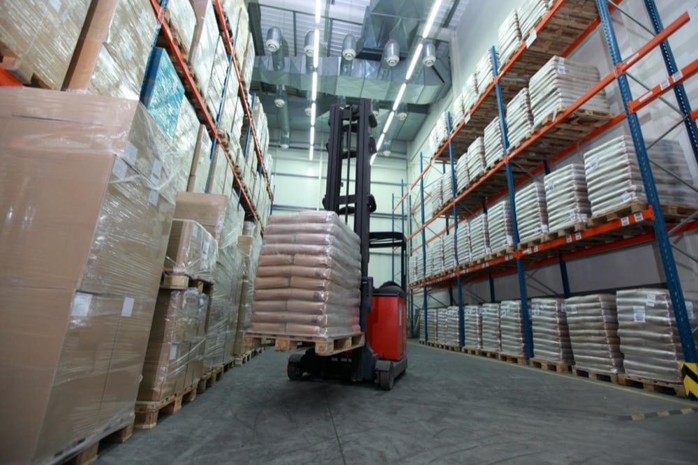 Forklift loader with pallet of sacks in distribution warehouse Hillphoenix Industrial Cold Storage Refrigeration Systems